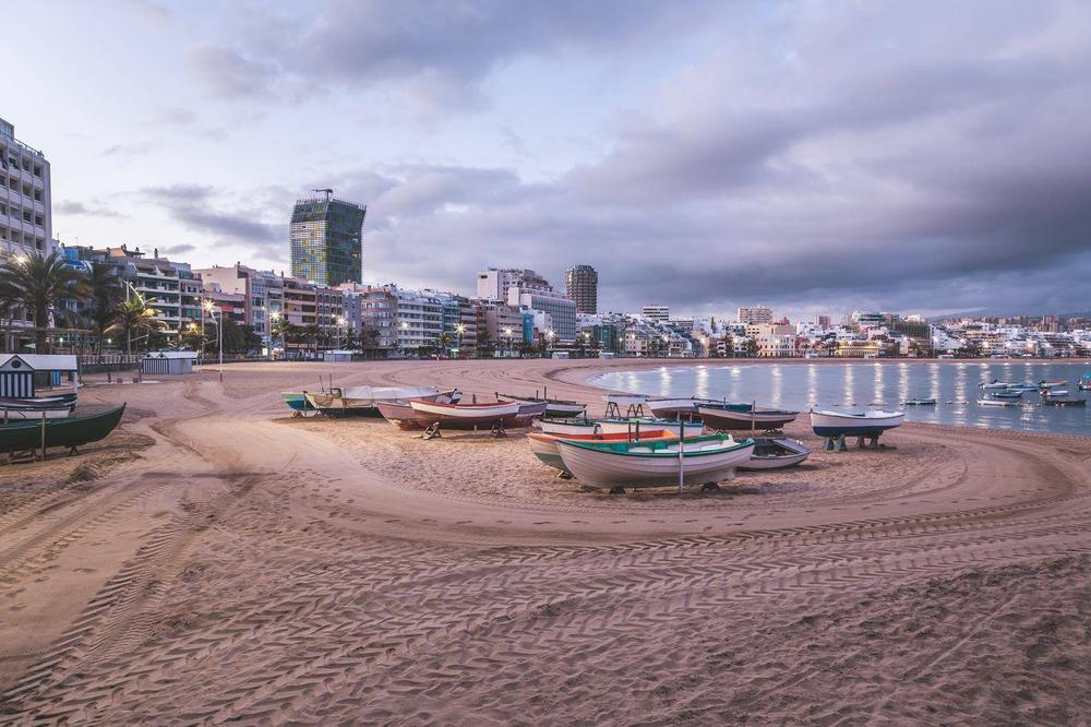 Amanecer en la playa de Las Canteras, Las Palmas de Gran Canaria, con barcas de pesca sobre la arena